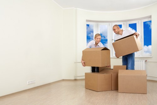 Packed moving boxes and furniture prepared for transport in Brompton