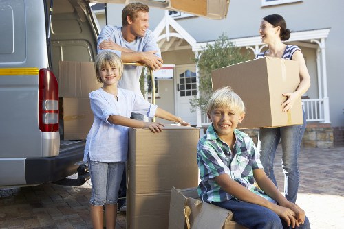 Boxes and furniture being unloaded from a moving truck