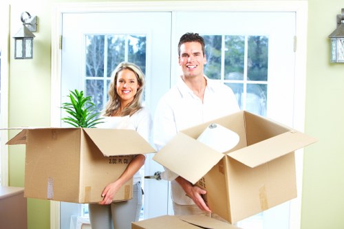 Prepared boxes and furniture ready for collection by a Brompton moving van