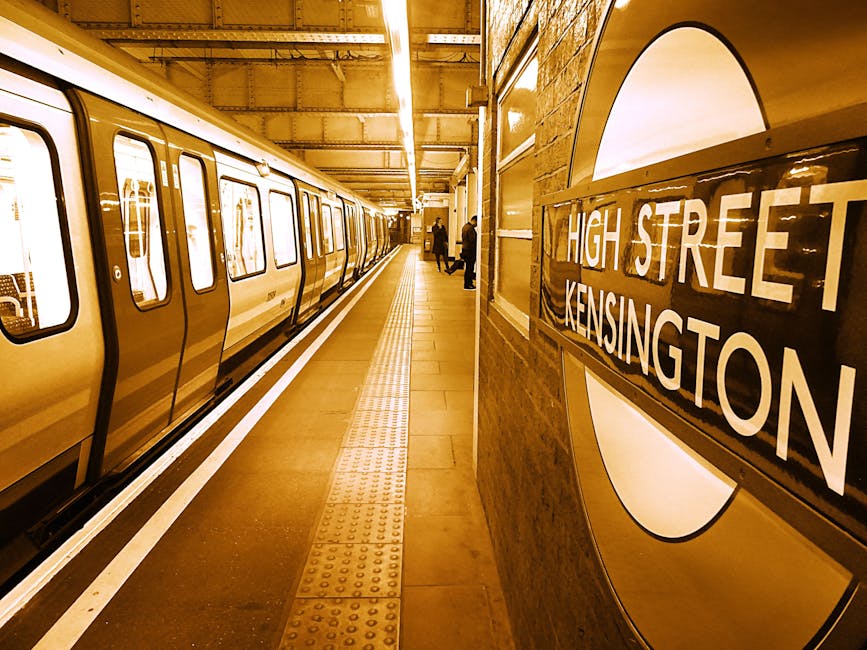 A rectangular white metal street sign mounted on a red brick wall, displaying the text 'WELCOME TO SOUTH KENSINGTON SW7' in black uppercase letters, with small red text for 'WELCOME TO' at the top and